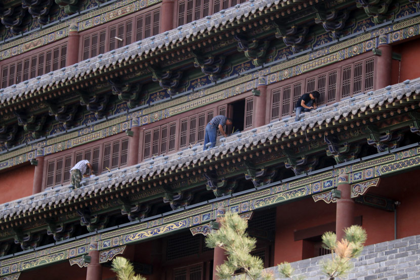 Workers add Ming and Qing Dynasty-style features to a building in Datong, Shanxi province, June 14, 2017. Chen Xiaodong/IC