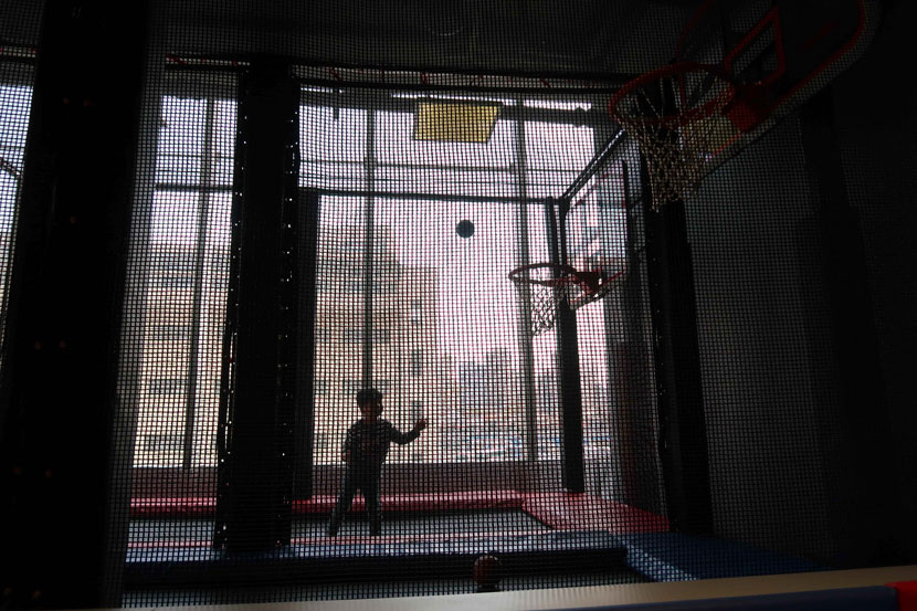 A child with autism plays basketball in Shanghai, March 31, 2019. People Visual