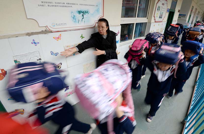 Students rush out of their classroom under their teacher’s guidance during an earthquake drill in Handan, Hebei province, Oct. 12, 2020. People Visual