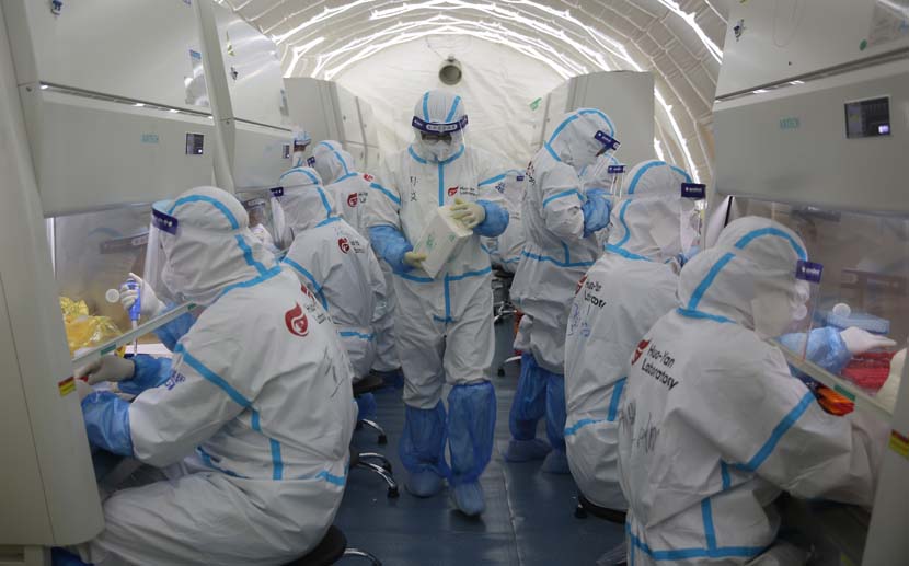 Medical workers are busy testing samples at Fire Eye Laboratory, a COVID-19 testing lab built with an inflatable structure, in Qingdao, Shandong province, Oct. 16, 2020. People Visual