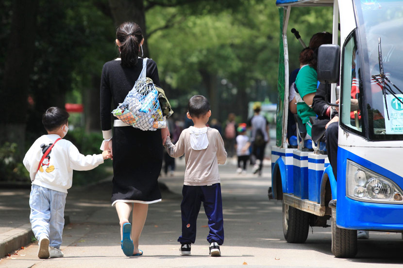 A mother takes her children to a park in Nanjing, Jiangsu province, May 10, 2020. Liu Jianhua/People Visual