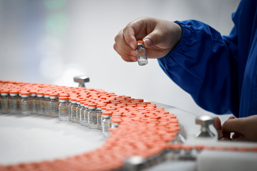 A staff member works on the production line for Sinovac’s COVID-19 vaccine in Beijing, Sept. 24, 2020. People Visual
