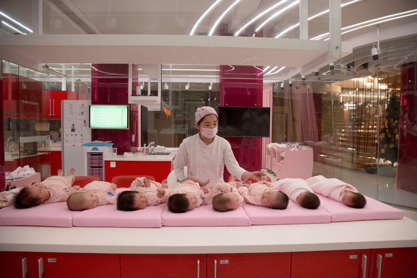 A nurse takes care of newborn babies at a private postnatal care center in Hangzhou, Zhejiang province, Feb. 27, 2019. Shi Yangkun/Sixth Tone