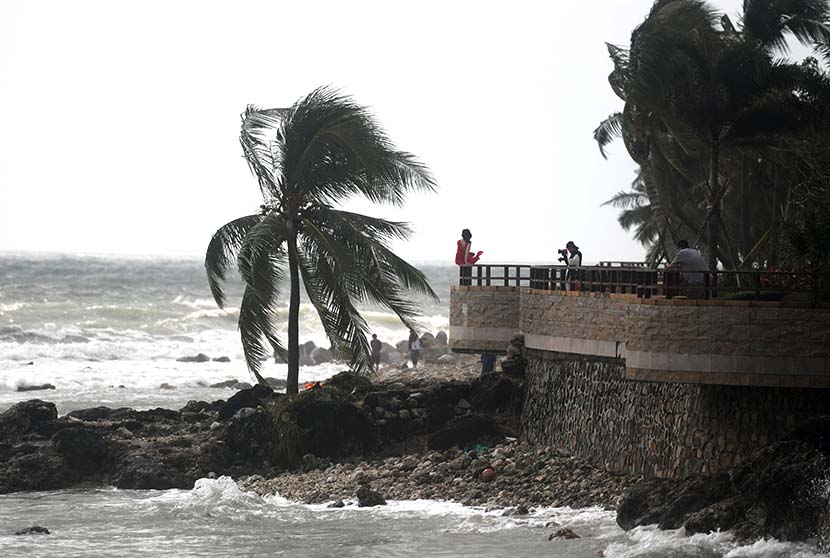 A woman is photographed by the sea on a windy day as Typhoon Goni approaches the South China Sea, Sanya, Hainan province, Oct. 29, 2020. People Visual