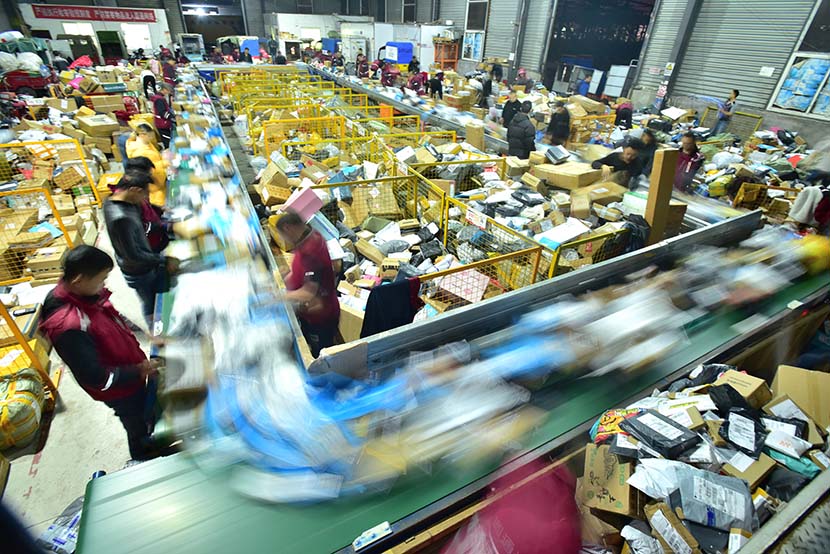 Workers sort parcels at a distribution center in Neijiang, Sichuan province, Nov. 16, 2018. People Visual