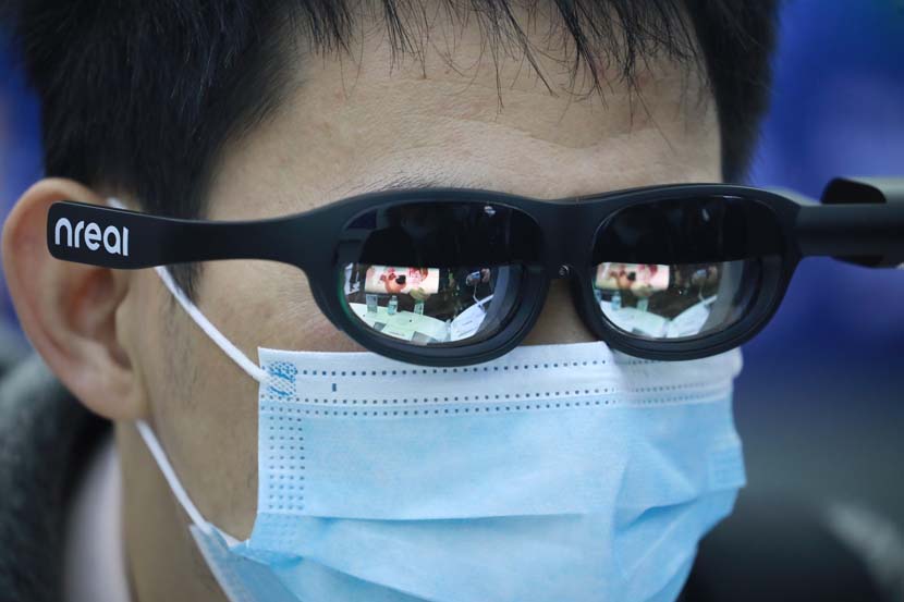 A man tries on “smart glasses” during the Light of Internet Expo in Jiaxing, Zhejiang province, Nov. 22, 2020. IC