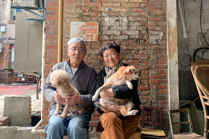 Lü Caiqiang and his wife pose for a photo in Pengpu New Village, Shanghai, Nov. 4, 2020. The couple raises two cats and two dogs. Wang Lianzhang/Sixth Tone