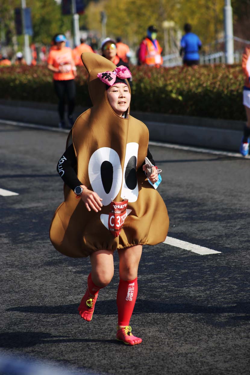 A woman dressed in a novelty costume takes part in the 2020 Shanghai International Marathon, the only Platinum Label road race in the world to take place this year, Shanghai, Nov. 29, 2020. People Visual