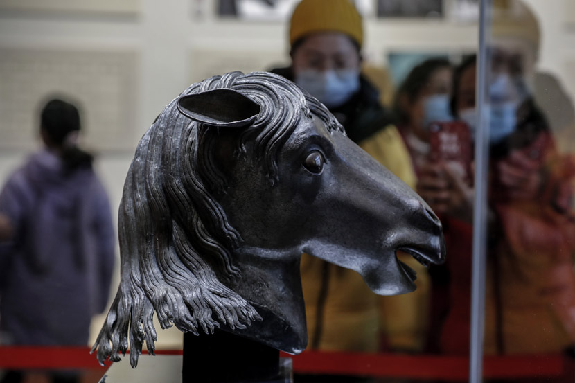 Visitors take photos of a returned bronze horse head sculpture that had been looted 160 years ago by invading Anglo-French forces at the Old Summer Palace, in Beijing, Dec. 3, 2020. People Visual