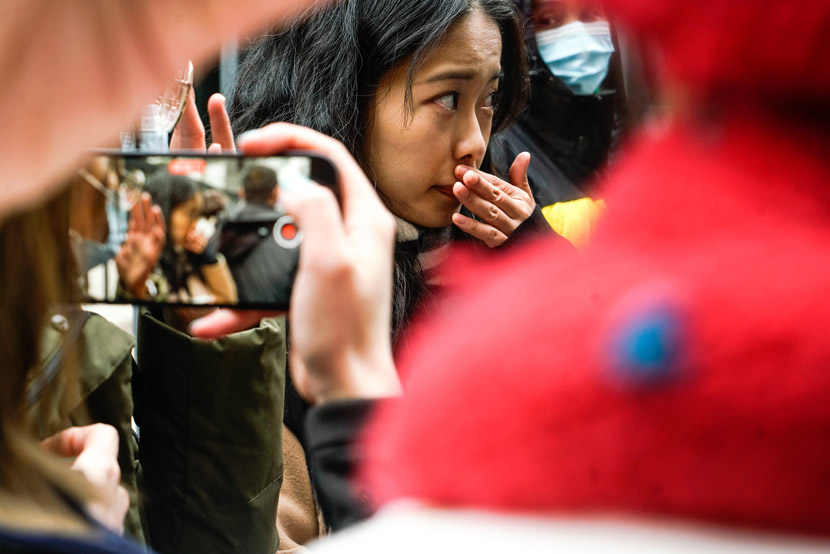 Xianzi, the pseudonym used by the alleged victim, arrives at the courthouse for her sexual harassment lawsuit against TV host Zhu Jun, in Beijing, Dec. 2, 2020. Shirly Cai for Sixth Tone
