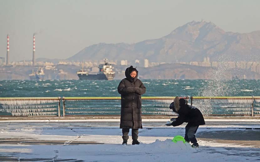 People play in the snow at the seaside in Dalian, Liaoning province, Dec. 13, 2020. People Visual