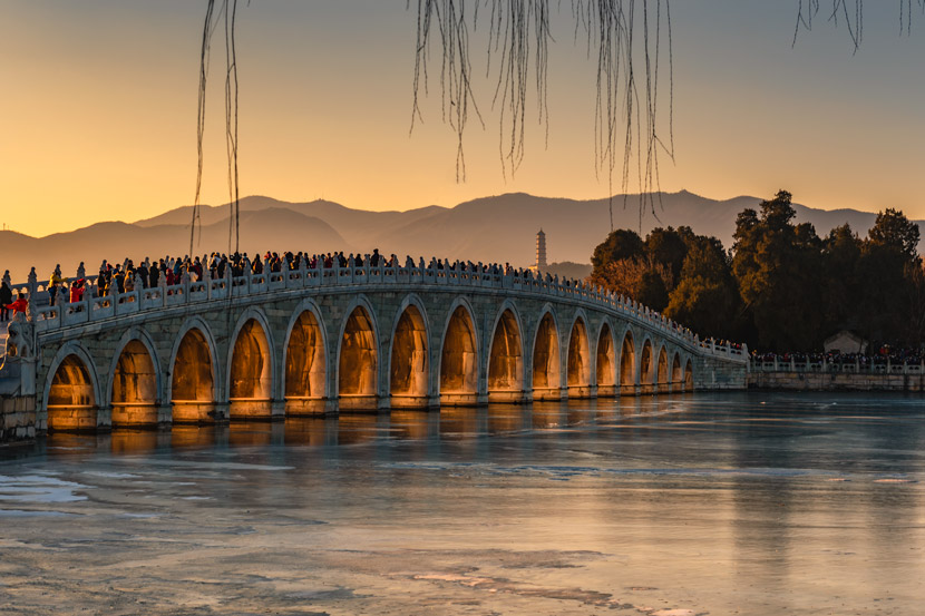 A view of Seventeen-Arch Bridge in the Summer Palace, Beijing, Dec. 20, 2020. The bridge is designed so that sunlight penetrates the arches during the Winter Solstice. People Visual