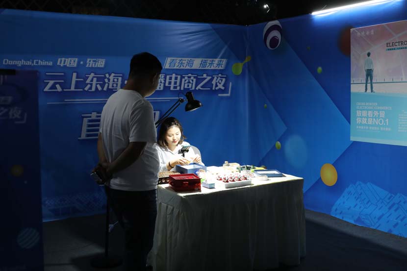A livestreamer sells crystals during a commercial livestreaming event in Donghai County, Jiangsu province, Sept. 28, 2020. People Visual