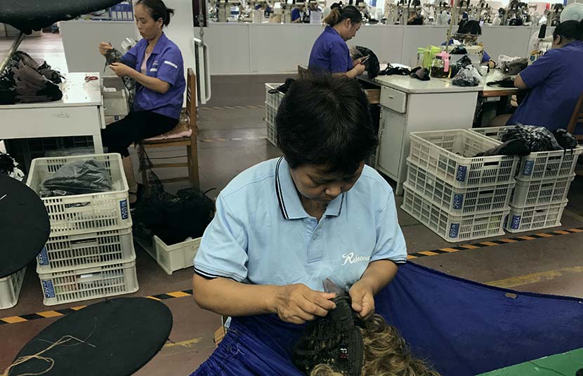 Workers make wigs at a factory in Xuchang, Henan province, July 3, 2018. People Visual