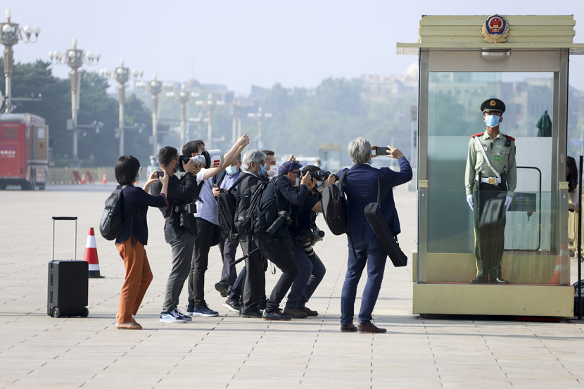 Journalists snap photos of a guard outside the Great Hall of the People in Beijing, May 22, 2020. This year’s “Two Sessions” legislative term, delayed by the coronavirus, finally commenced on May 21. People Visual