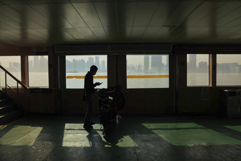 A man rides a ferry on the first day after Wuhan lifted its 76-day lockdown, Wuhan, Hubei province, April 8, 2020. People Visual