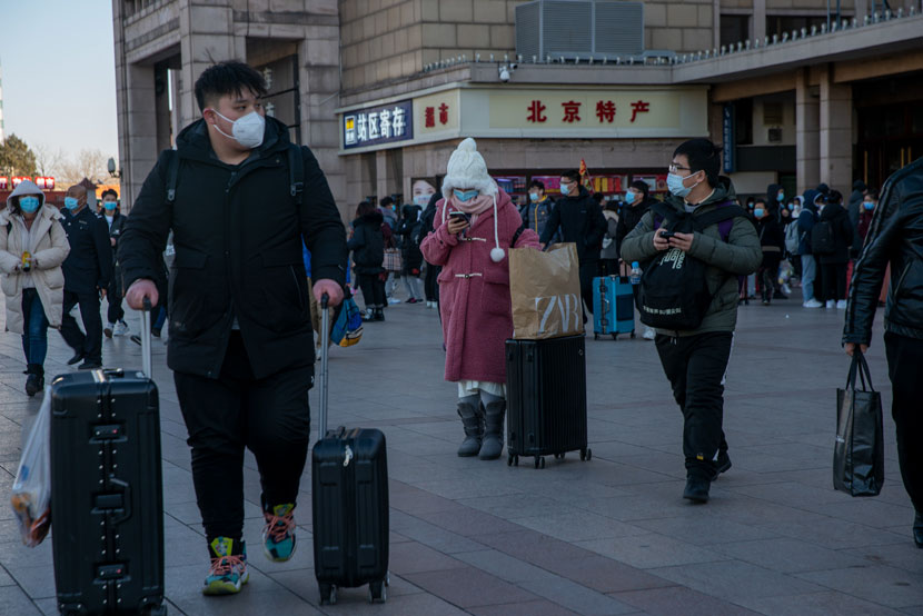 Tourists walk out of Beijing Railway Station in Beijing, Dec. 30, 2020. Wang Zicheng/IC