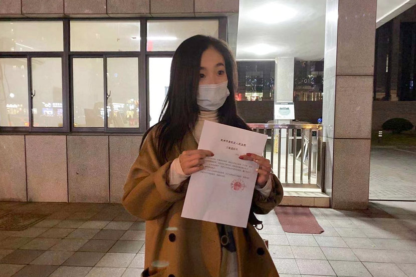 Wu Min holds the notice verifying her case was accepted outside the court in Hangzhou, Zhejiang province, December 2020. Courtesy of Wu Min