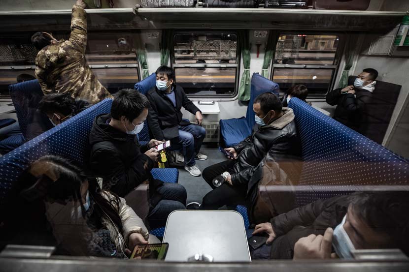 Passengers aboard the first “chunyun” train leaving from Beijing Railway Station, Jan. 28, 2021. People Visual