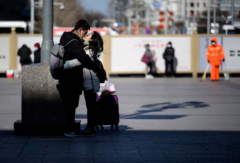 A couple parts with a kiss on the first day of the Spring Festival travel period outside Beijing Railway Station, Jan. 28, 2021. People Visual