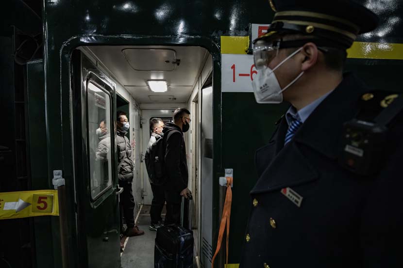 Passengers board the first “chunyun” train leaving from Beijing Railway Station, Jan. 28, 2021. People Visual