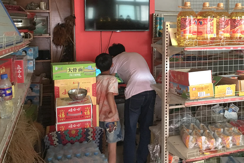 Villagers buy goods at an e-commerce store, 2016. Courtesy of Zhang Wenxiao
