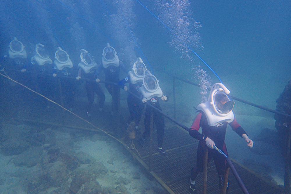 Tourists experience an underwater sea walk in Sanya, Hainan province, Feb. 15, 2021. People Visual