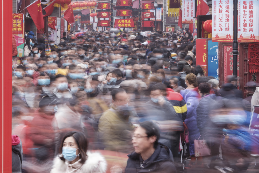 Visitors crowd the Ancient Culture Street in Tianjin, Feb. 13, 2021. People Visual