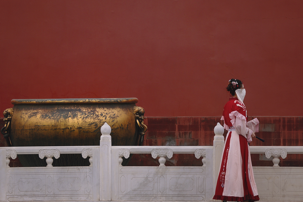 A young woman in traditional Chinese “hanfu” clothing walks through the Palace Museum in Beijing, Feb. 12, 2021. People Visual