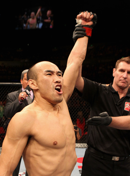 Zhang Tiequan celebrates after defeating Jason Reinhardt of the USA during their featherweight bout at UFC 127 in Sydney, Australia, Feb. 27, 2011. Josh Hedges/Zuffa LLC/People Visual