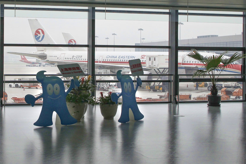 Signs featuring the Expo 2010 mascot are displayed at Shanghai Hongqiao Airport, 2010. People Visual