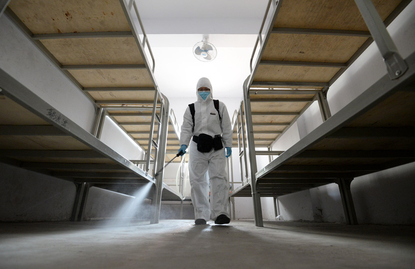 A worker sprays disinfectant inside a student dormitory in Handan, Hebei province, Feb. 26, 2021. Hao Qunying/People Visual