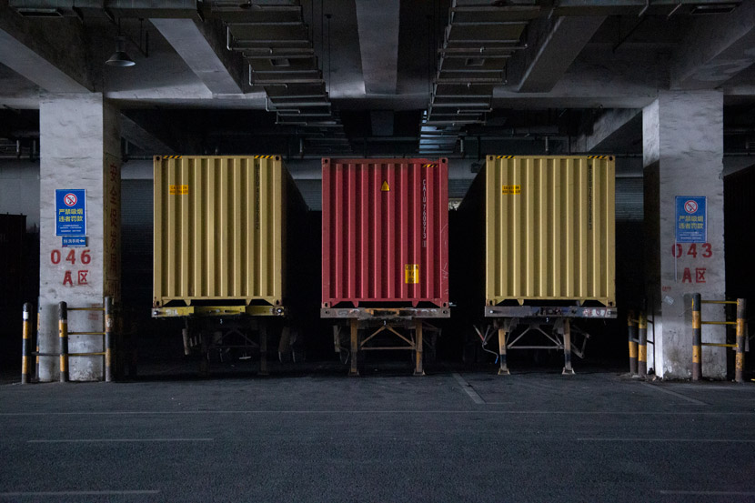 Containers are stacked inside a warehouse in Yiwu, Zhejiang province, March 14, 2021. Wu Peiyue/Sixth Tone
