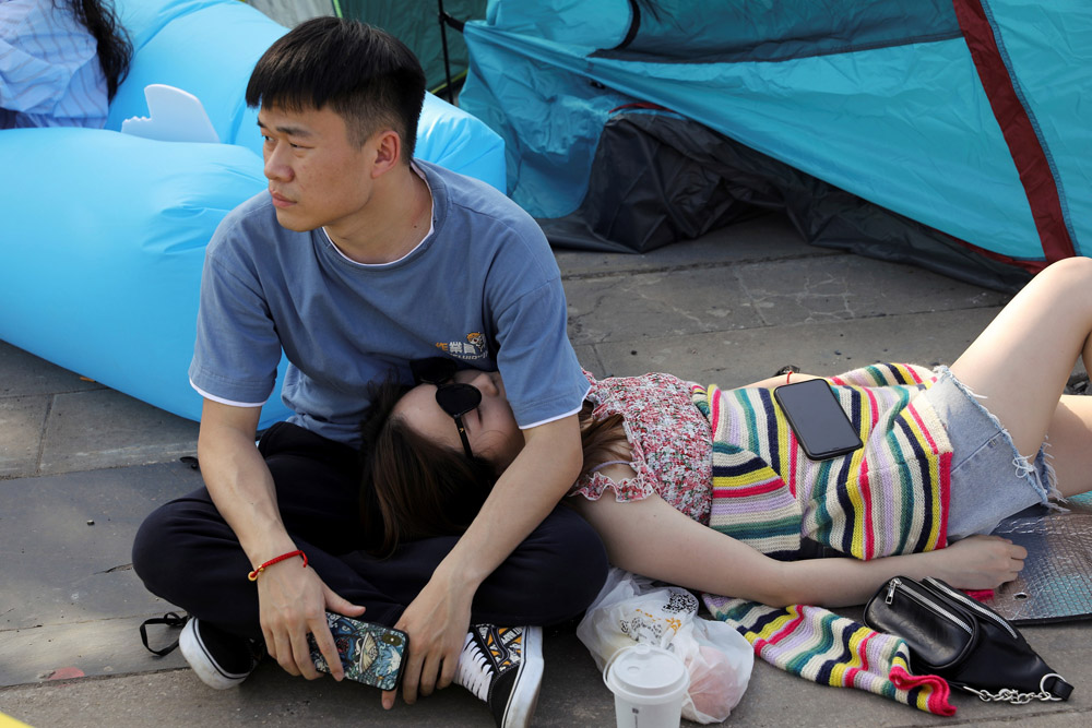 A couple takes a break during the Strawberry Music Festival in Wuhan, Hubei Province, May 1, 2021. Tingshu Wang/Reuters/IC