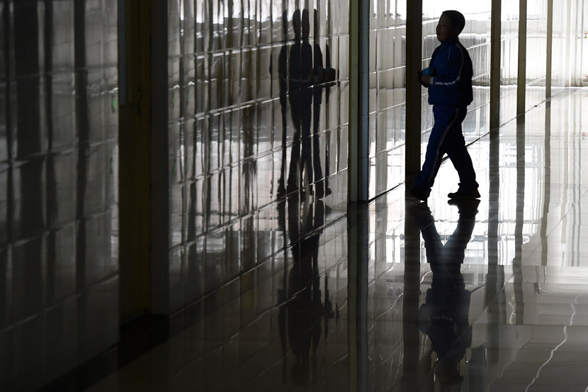 A boy enters a classroom in Taiyuan, Shanxi province, 2014. People Visual