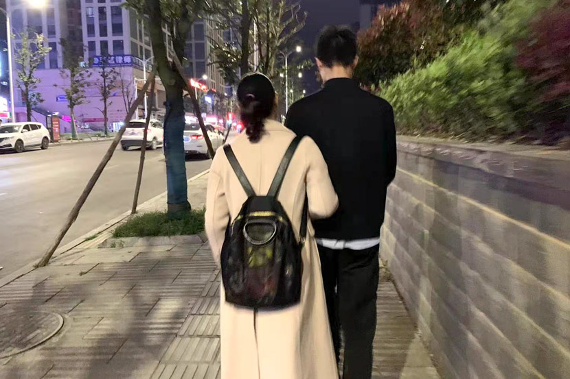 Chen Sihan and his mother Li Ronghui walk down a street in Guizhou province, 2021. Courtesy of Han Qian