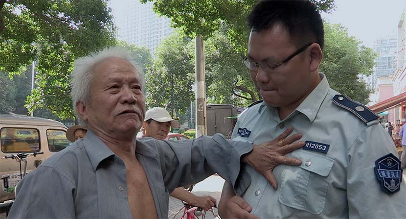 A screenshot from the film shows Wang Tiancheng clashing with an urban management officer. Courtesy of Dai Nianwen
