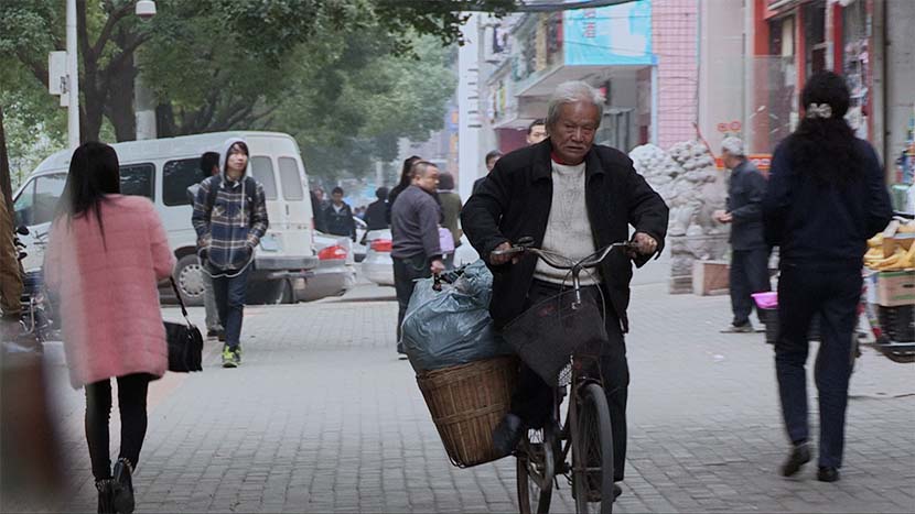 A screenshot from the film shows Wang Tianchen riding a bike. Courtesy of Dai Nianwen