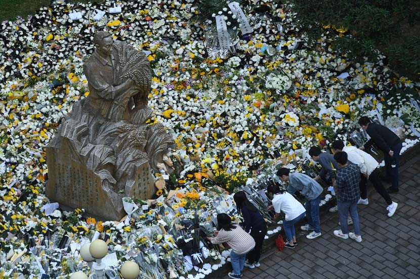 People leave flowers and other mementos at the statue of Yuan Longping on the campus of his alma mater, Southwest University, in Chongqing, May 23, 2021. People Visual
