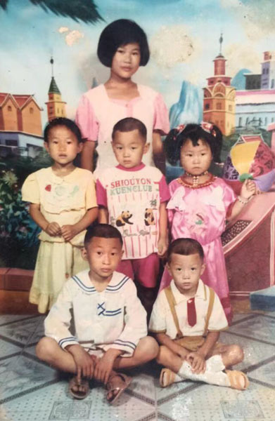 A family photo of Li Dongmei (back row), her third sister (second row, far left), and her cousins. The picture was taken shortly after her mother died. Courtesy of Li Dongmei