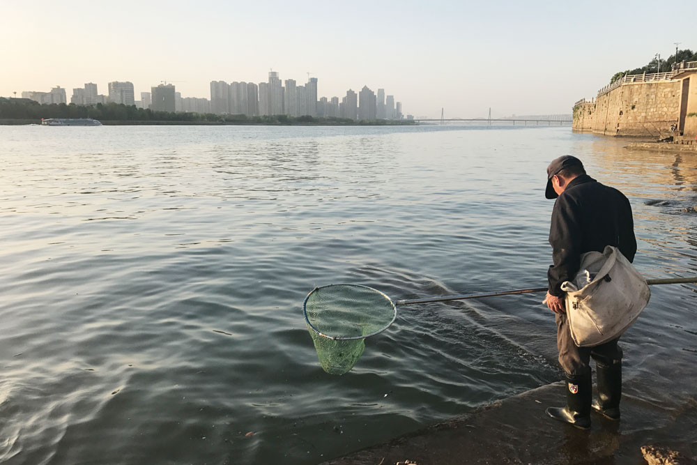 A man fishes by the Xiang River in Chanhgsha, Hunan province, April 2018. Courtesy of Yang Xiao