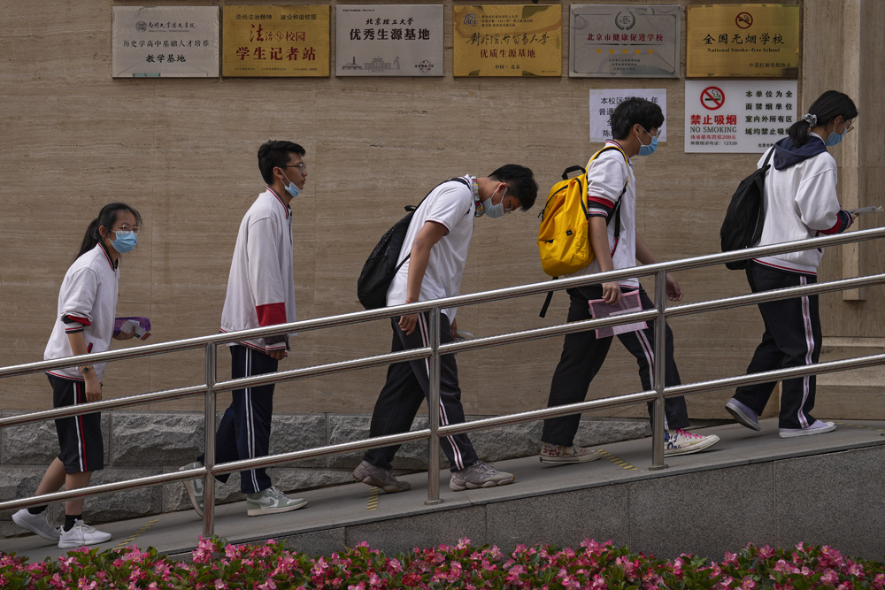 Students enter an examination site in Beijing, June 7, 2021. People Visual