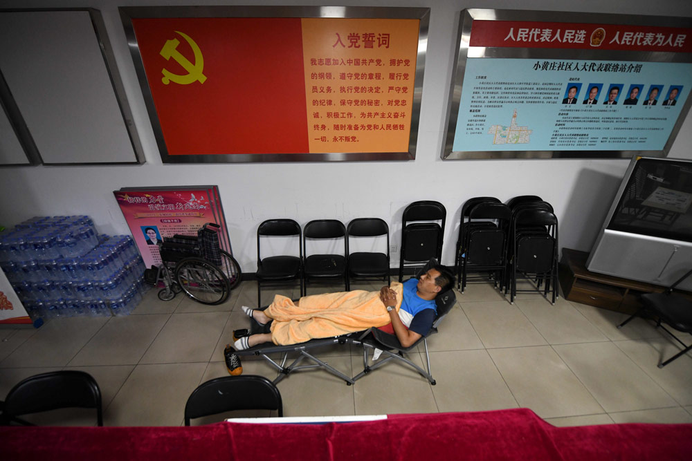A community worker takes a break in an office in Beijing, June 2020. He Guanxin/People Visual