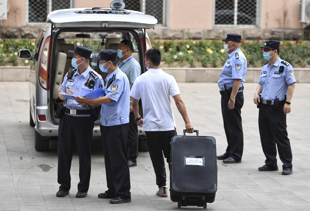 Under police supervision, “gaokao” test papers are transferred to a vehicle in Beijing, June 7, 2021. People Visual