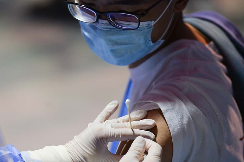 A student gets vaccinated at a college in Beijing, March 28, 2021. People Visual