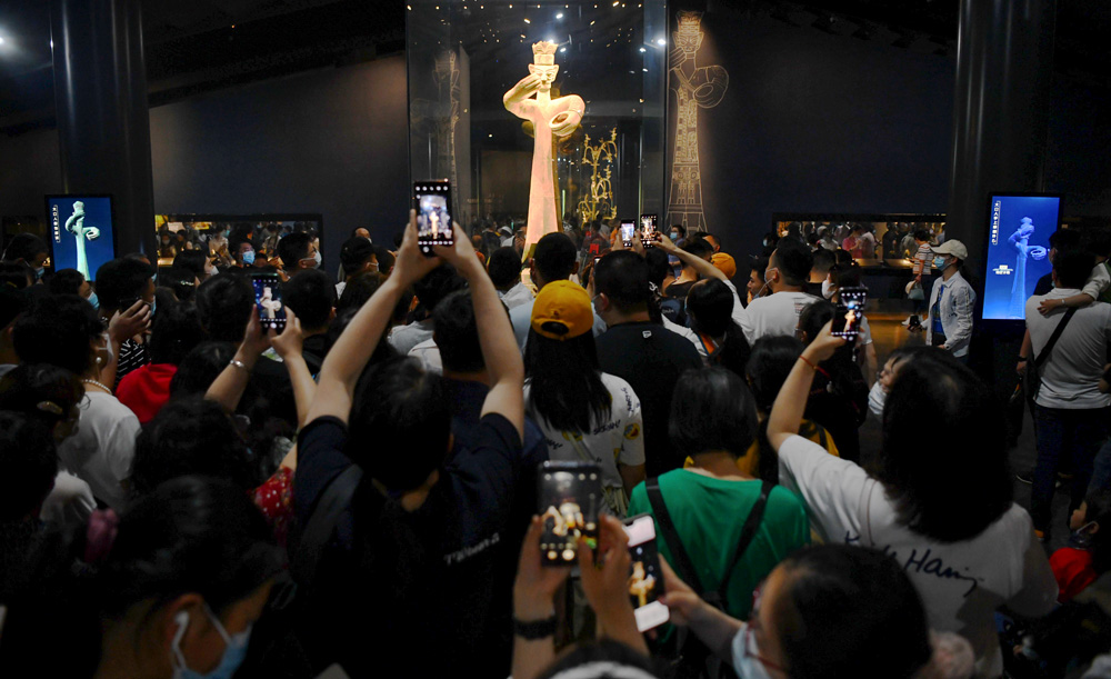 Tourists take photos of the Large Standing Figure at the Sanxingdui Museum, in Guanghan, Sichuan province, May 2021. The recent finds at Sanxingdui has renewed public interest in the project. Zhang Lang/CNS/People Visual