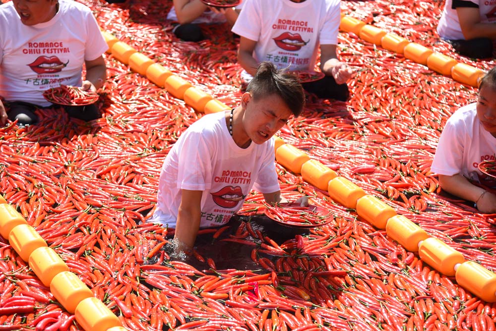 Tourists try to stay afloat during a chili-eating competition in Hangzhou, Zhejiang province, 2019. Located along the eastern coast, Hangzhou is not a traditional center of chili consumption. Lian Guoqing/People Visual