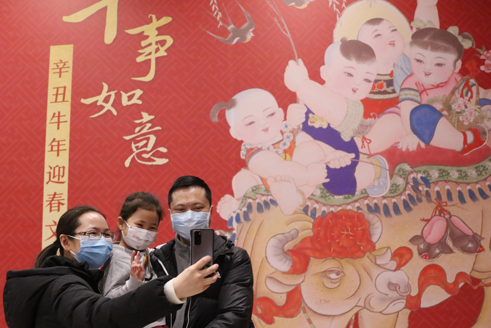 A family takes a selfie in Beijing, Feb. 10, 2021. People Visual