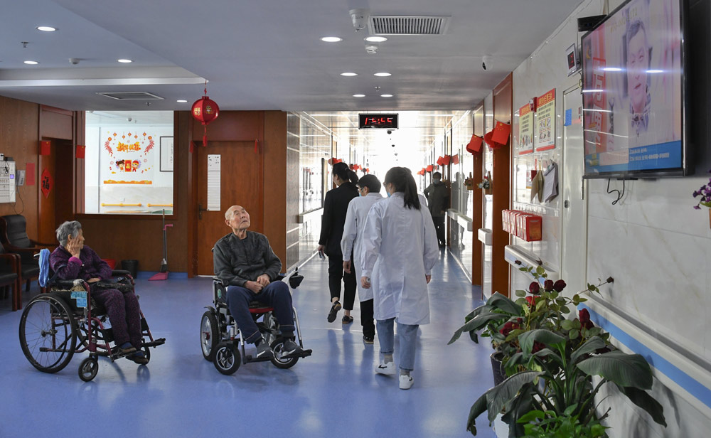 Elderly residents watch TV at a nursing home in Hebi, Henan province, April 16, 2021. Zhang Dan/People Visual