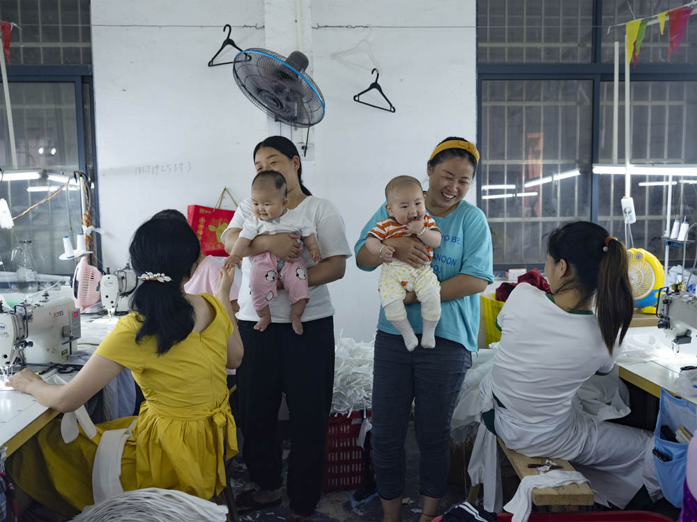 Former Plus Ten employees visit the factory with their newborn children, June 2021. Courtesy of Lü Meng